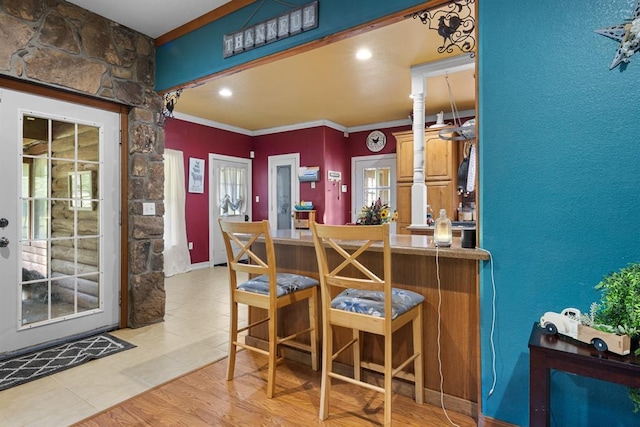 kitchen featuring ornamental molding and a breakfast bar area