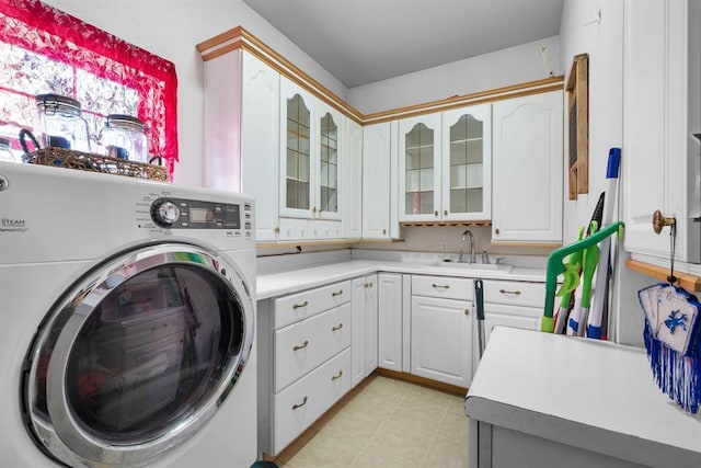 washroom with cabinets, washer / dryer, and sink