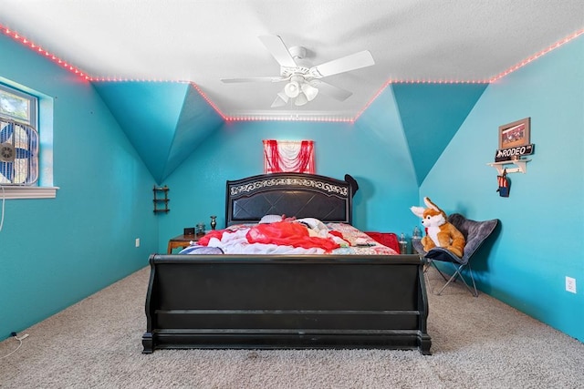 bedroom with ceiling fan, carpet flooring, and vaulted ceiling