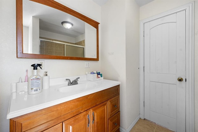 bathroom featuring vanity, tile patterned floors, and a shower with door