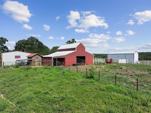 view of yard with an outdoor structure and a rural view