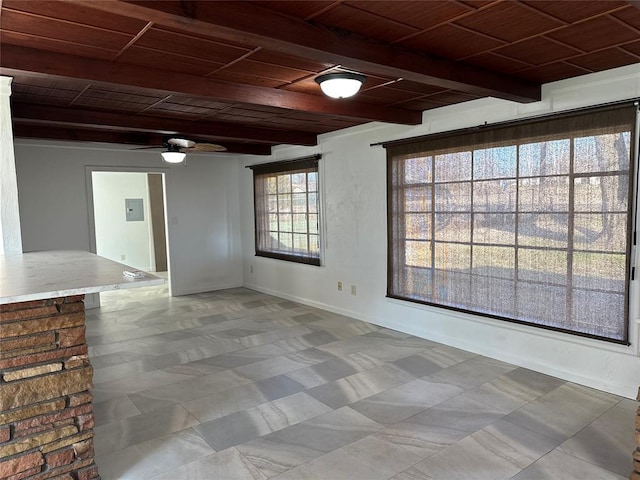 empty room with ceiling fan, beamed ceiling, and wooden ceiling