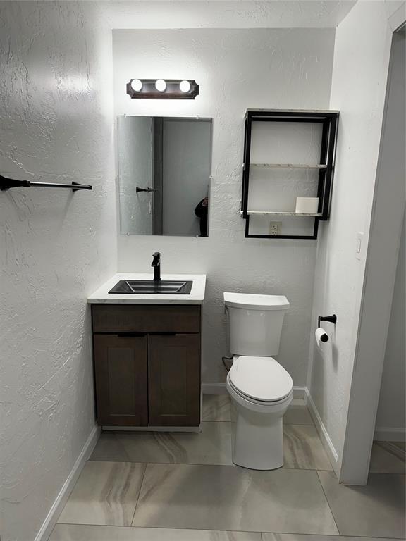 bathroom featuring toilet and vanity