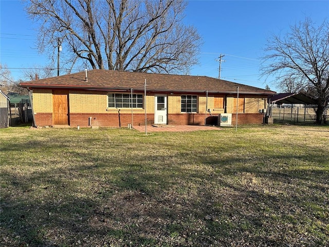 rear view of property featuring a patio area and a lawn