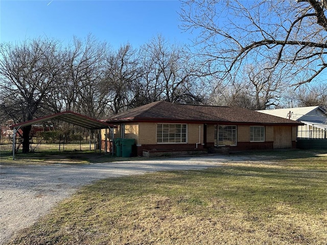 view of front of house featuring a front lawn and a carport