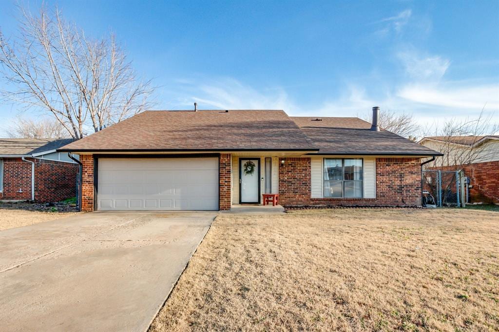 single story home featuring a front yard and a garage