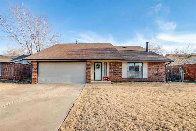 single story home featuring a front yard and a garage