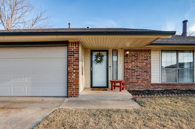 doorway to property with a garage