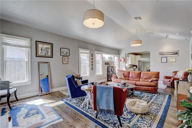 living room with wood-type flooring and vaulted ceiling