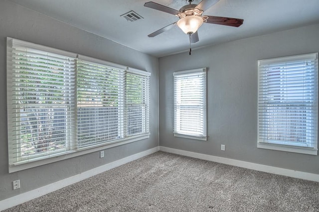 carpeted spare room with ceiling fan