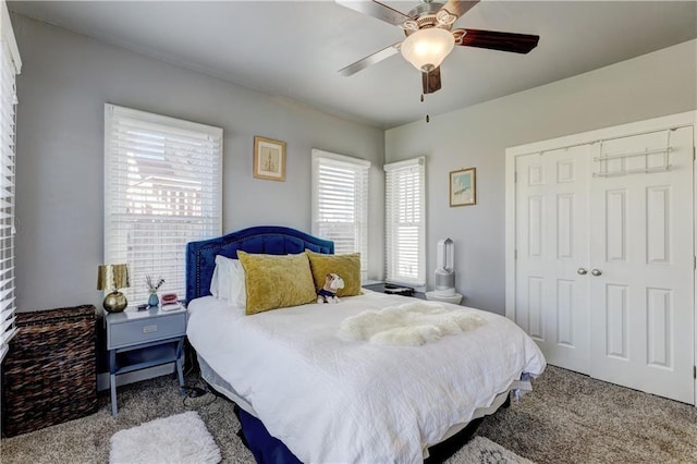 carpeted bedroom featuring a closet and ceiling fan