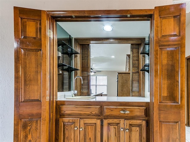 interior space featuring ceiling fan and sink