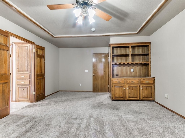 unfurnished living room featuring a textured ceiling, light colored carpet, and ceiling fan