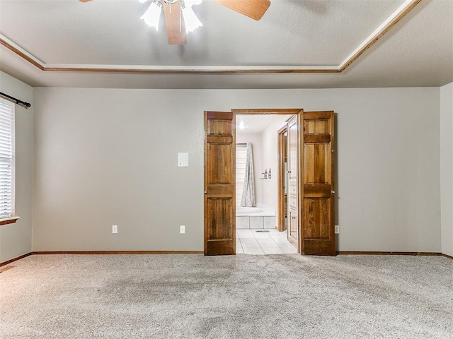 carpeted empty room with ceiling fan and a textured ceiling