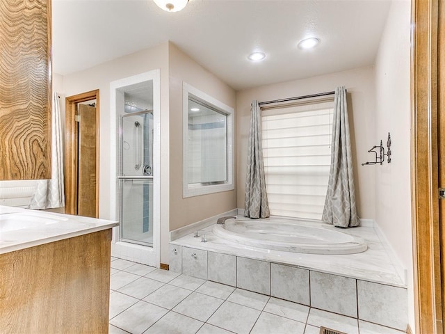 bathroom with tile patterned flooring, vanity, and shower with separate bathtub