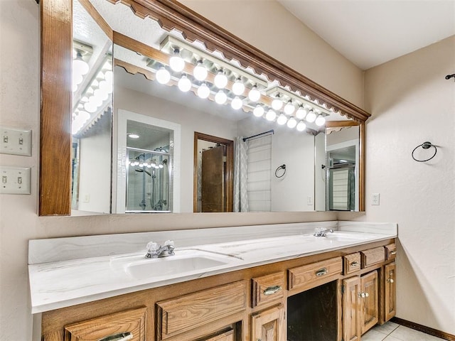 bathroom with a shower, vanity, and tile patterned floors