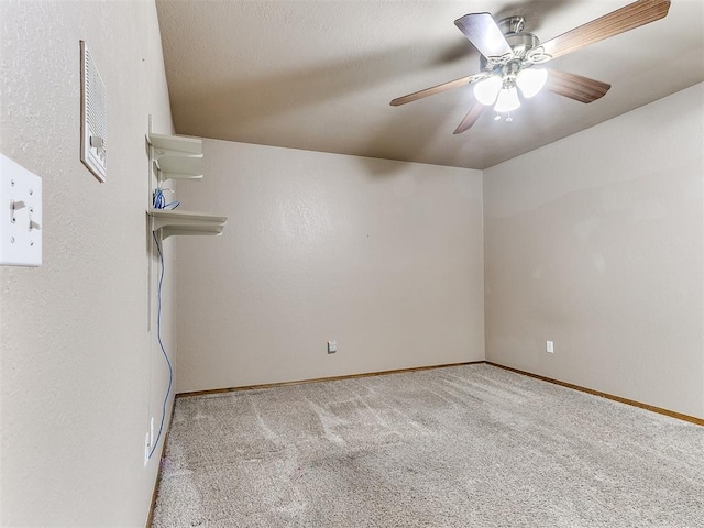 carpeted spare room with ceiling fan