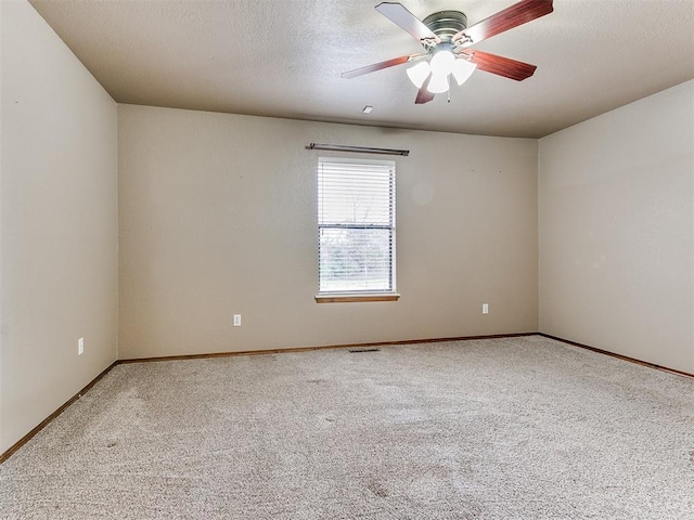 carpeted empty room featuring a textured ceiling and ceiling fan