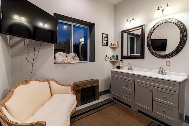 bathroom with a fireplace and vanity