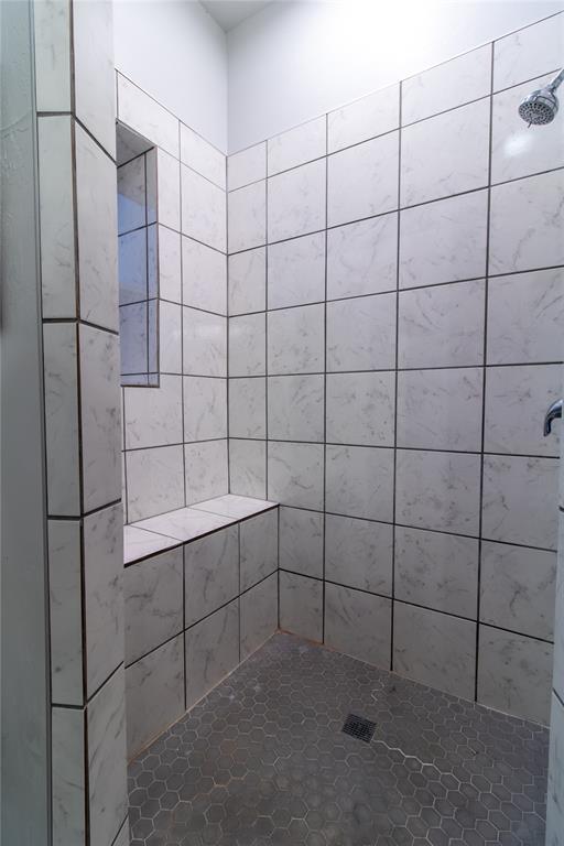 bathroom with a tile shower