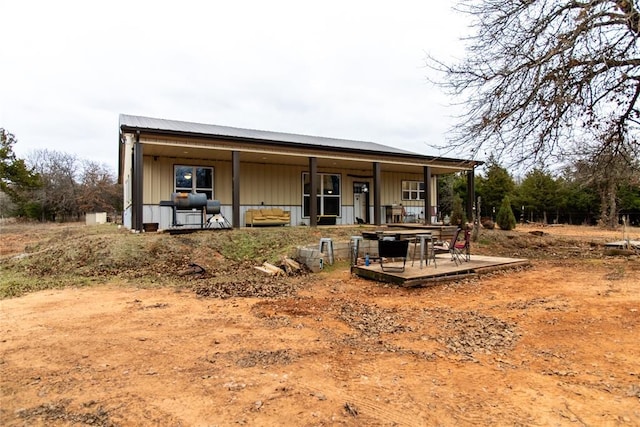 rear view of house featuring covered porch