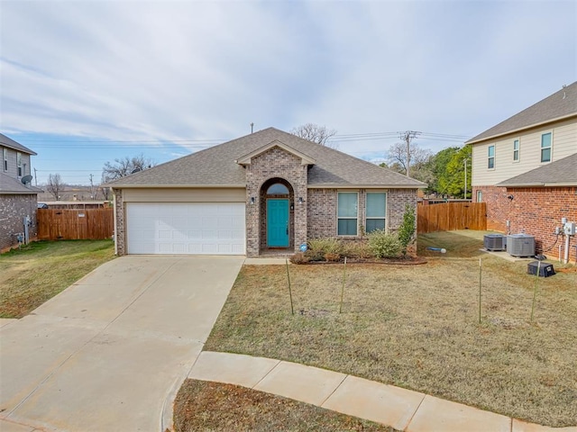 view of front of property with a garage, a front lawn, and cooling unit