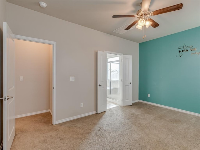 unfurnished bedroom with ceiling fan and light carpet