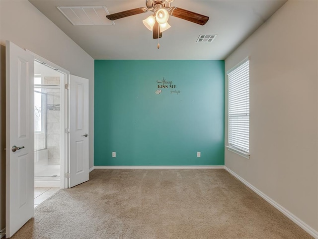 carpeted empty room featuring ceiling fan