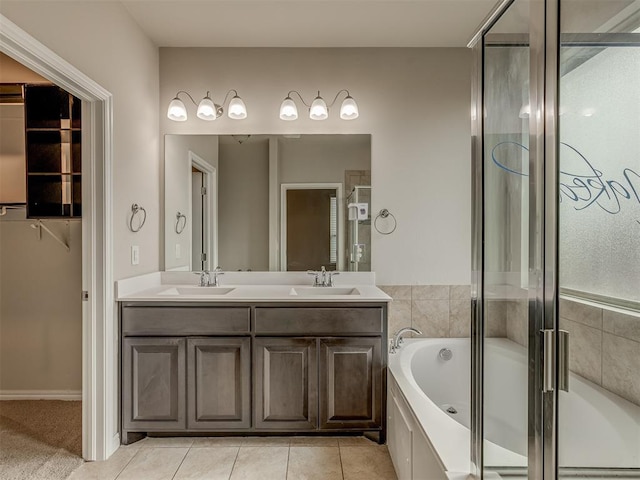 bathroom with shower with separate bathtub, vanity, and tile patterned floors