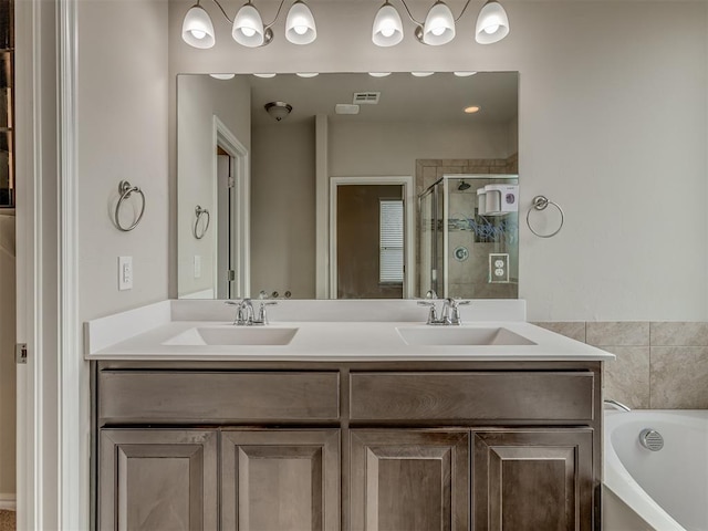 bathroom featuring separate shower and tub and vanity