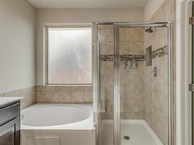 bathroom featuring vanity, a healthy amount of sunlight, and shower with separate bathtub