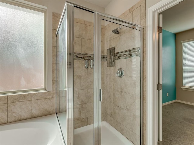 bathroom featuring plenty of natural light and plus walk in shower