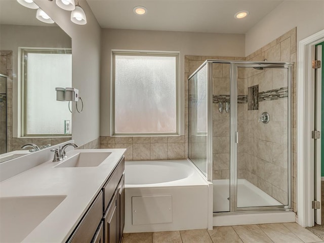 bathroom featuring shower with separate bathtub, vanity, tile patterned floors, and plenty of natural light