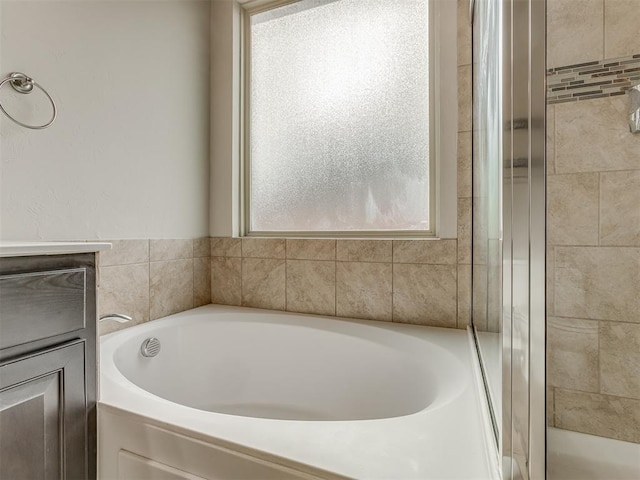 bathroom featuring separate shower and tub