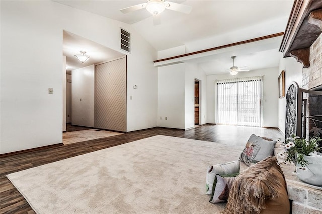 unfurnished living room featuring a stone fireplace, ceiling fan, vaulted ceiling, and hardwood / wood-style flooring