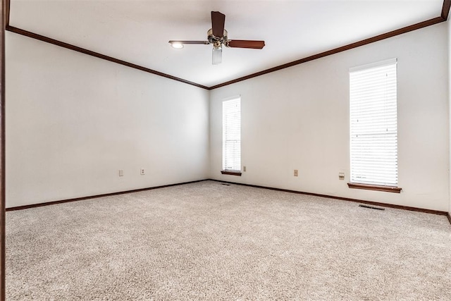 unfurnished room with carpet flooring, ceiling fan, and plenty of natural light