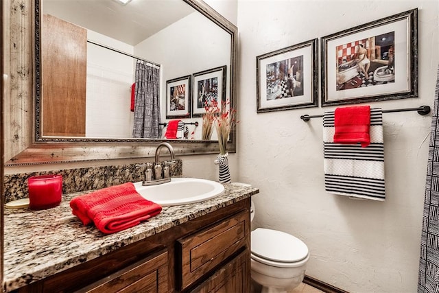 bathroom featuring vanity, toilet, and walk in shower