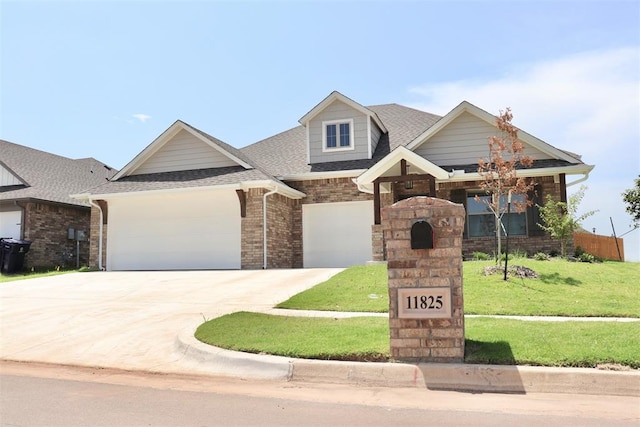 craftsman house with a front yard and a garage