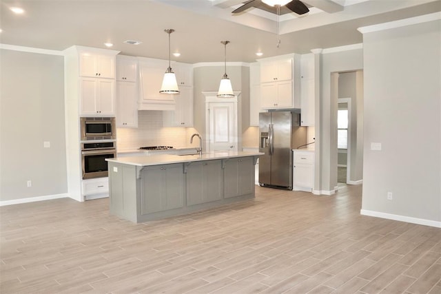 kitchen with white cabinetry, ceiling fan, sink, a center island with sink, and appliances with stainless steel finishes