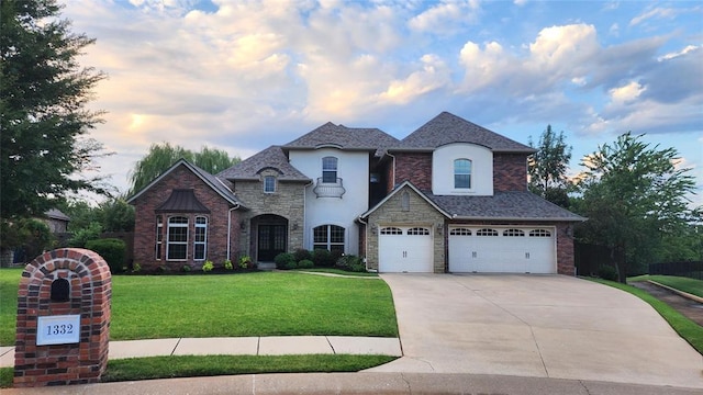 french country style house featuring a lawn and a garage