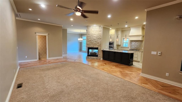 kitchen featuring appliances with stainless steel finishes, ornamental molding, custom range hood, light parquet floors, and white cabinetry