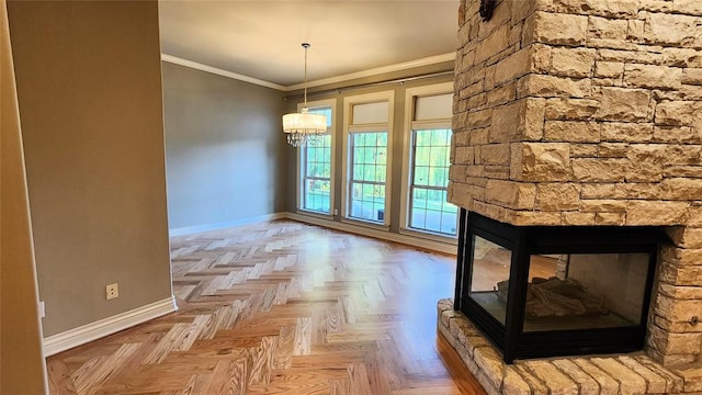 unfurnished dining area with a stone fireplace, light parquet floors, a chandelier, and ornamental molding