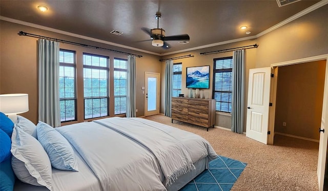 carpeted bedroom with ceiling fan and crown molding