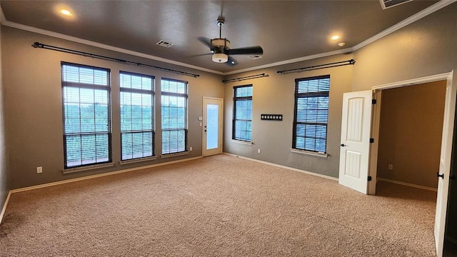 carpeted empty room with ceiling fan and crown molding