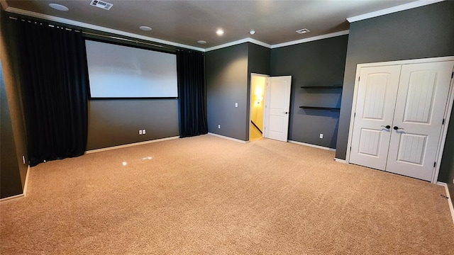 carpeted cinema featuring ornamental molding