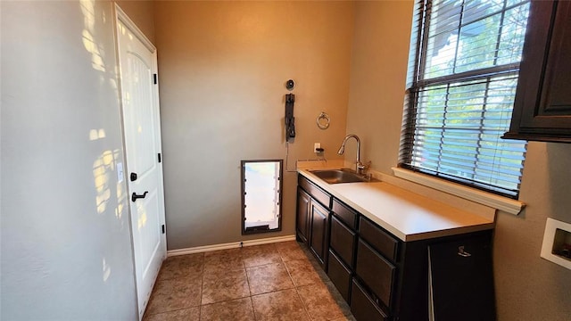 interior space featuring sink and light tile patterned flooring