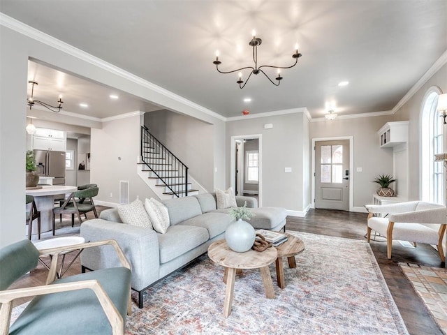 living room with a chandelier, wood-type flooring, and crown molding