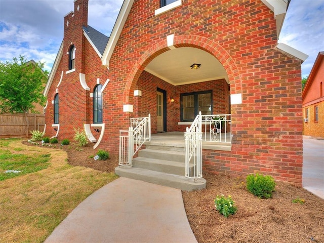 view of exterior entry featuring covered porch