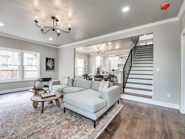 living room featuring hardwood / wood-style floors, an inviting chandelier, and ornamental molding