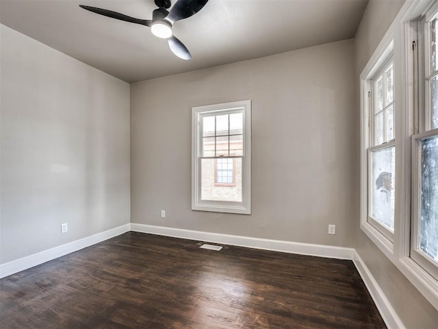 unfurnished room with ceiling fan and dark wood-type flooring